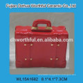 Colorful ceramic piggy bank in suitcase shape